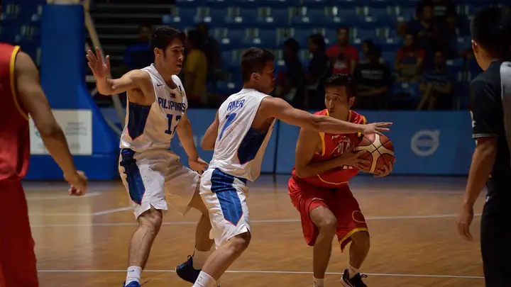 Philippine national basketball players defend against Malaysia at the 2015 Southeast Asian Games